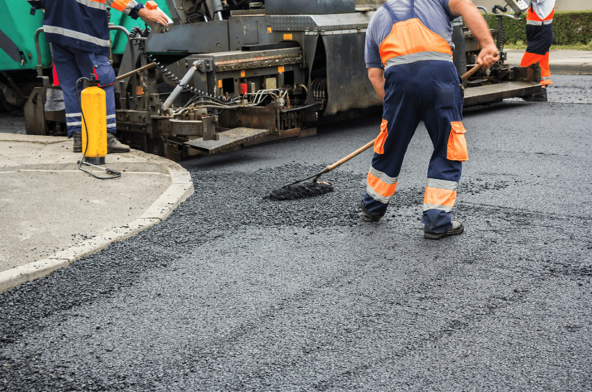 man repairing asphalt